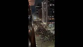 Overhead View Shows Protesters Against ICE Marching in Minneapolis, Fireworks Going Off