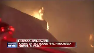 Flames burst through roof of east side home