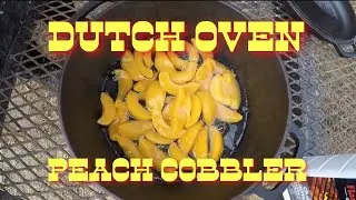 Dutch oven peach cobbler on hot coals
