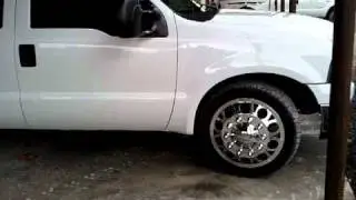 lowered Ford dually on 22 inch american force wheels