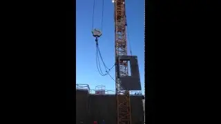 Rotation of the precast panel using two tower cranes