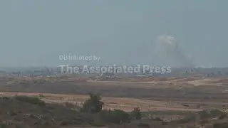 Seen from southern Israel, smoke rises over the Gaza skyline