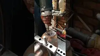 USING GRINDING WHEEL TO POLISH IN CATERPILLAR AXLE HUB HELD ON ADJUSTABLE TABLE FROM UNIVERSAL MACHI