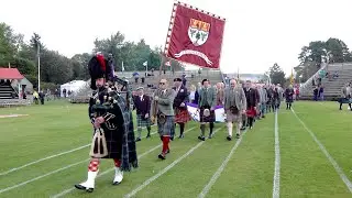 Start of the 2019 Braemar Gathering as Highland Society are led into games field by official piper