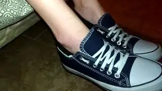 Taking off her blue converse and no show socks