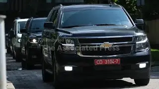 Cars carrying released Belarusian dissidents arrive at the US Embassy in Vilnius