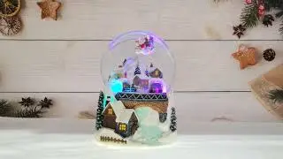 Flying Santa and Revolving Train Snow Globe with LED light effects and automatic glitters blowing