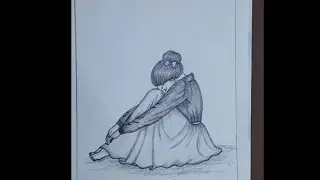 A sad girl drawing, sitting and hugging her knees  to make herself  feel better 