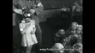 Children learn to use gas masks during World War Two archival stock footage