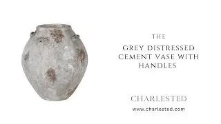 The grey distressed cement vase with handles