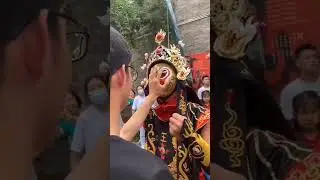 A Bian Lian magic artist changes his mask in no time