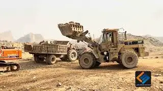 ۔Massive rocks loading with caterpillar machine heavy equipment in action