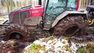 Valtra A93 forestry tractor with big trailer in wet forest