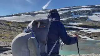 Old hiker solo in the mountains in Norway.