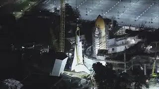 Massive crane hoists Space Shuttle Endeavour for vertical display
