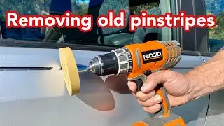 Removing old pinstripes from a car with a decal eraser wheel and razor blade.