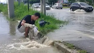 One Man vs Plastic Waste Cleaning a Flooded Road Drain