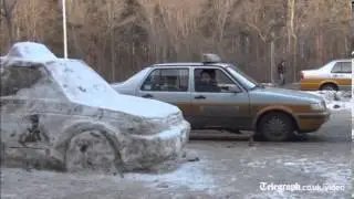 A car made of snow baffles residents when it appears at a taxi rank over night