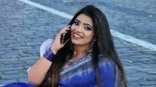 Young Indian woman smiling making phone call on cobblestone street in Moscow
