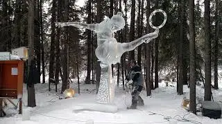 Ice Carving Championship in Alaska - Aaron & Jim chainsaw the brace out from under a large sculpture