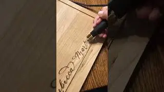Freehand woodburned cutting board charcuterie board calligraphy lettering and wildflowers