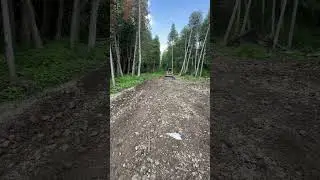 Spreading gravel on big driveway with skid steer loader