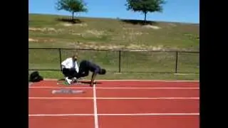 Akwasi Frimpong receiving starting blocks tips from world-class coach Wendell Prince @ Olympic Camp