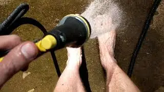 Rinsing my size 16 feet with the hose after a long day of yard work.