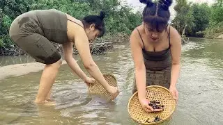 Primitive life in Asia: Top fishing clams in river with basket bamboo