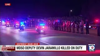 Motormen escort ambulance with body of slain MDSO deputy