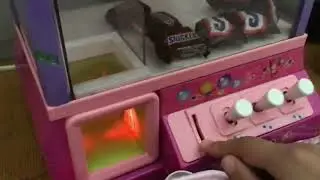 Music claw machine candy grabber with snickers ufo catcher in Japan