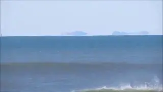 Inferior mirage of a ship and distant land