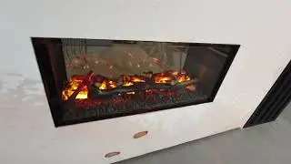 Chemin&eacute;e &agrave; vapeur d'eau traversante et ses b&ucirc;ches d&eacute;coratives