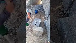 hitting various large grey stones with a metal hammer in a bright outdoor stone quarry area today