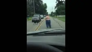 Fat guy chasing dog down street
