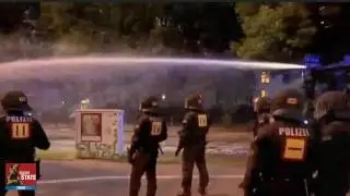 German ANTIFA thugs throw Paint at German Riot Police they Respond with Water Cannons!!!