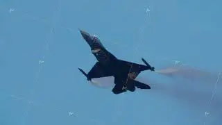 Fighter jet ascending with smoke trails during airshow performance