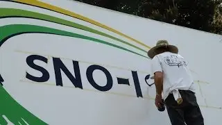 Sno-Isle Libraries billboard painter at AquaSox stadium