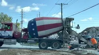 Red White and Blue Patriotic Mixer Truck Pouring Concrete at Construction Site
