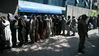 People line up at banks in Kabul | AFP