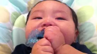 Nate enjoying the RaZbaby Raz-Berry Silicone Teether - Blue