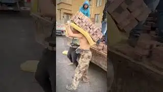 the process of workers lifting a load of red bricks from a truck #shorts
