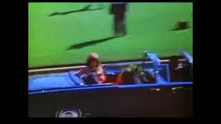 Excerpt from Zapruder film showing presidential motorcade traveling by Jean Hill and Mary Moorman