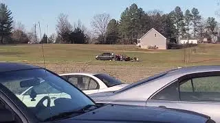 Neighbor is skeet shooting and Kelley drives by.