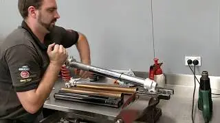 Grant removing WP chrome tube from boot