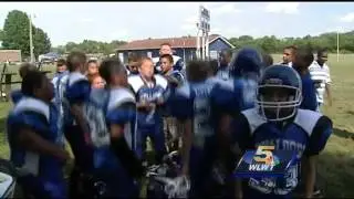 Peewee football team remembers slain coach at first home game