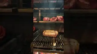 Savoring the smoky magic as tender meat sizzles over a roaring wood fire.