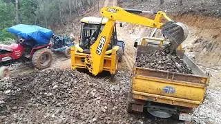jcb 3dx super loading stone into a dump truck## jcb working in stone quarry