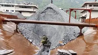 Manual barge unloading, camo guy takes out first board