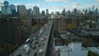 Aerial ascending footage of metropolis. Busy multilane highway with constant streams of vehicles and